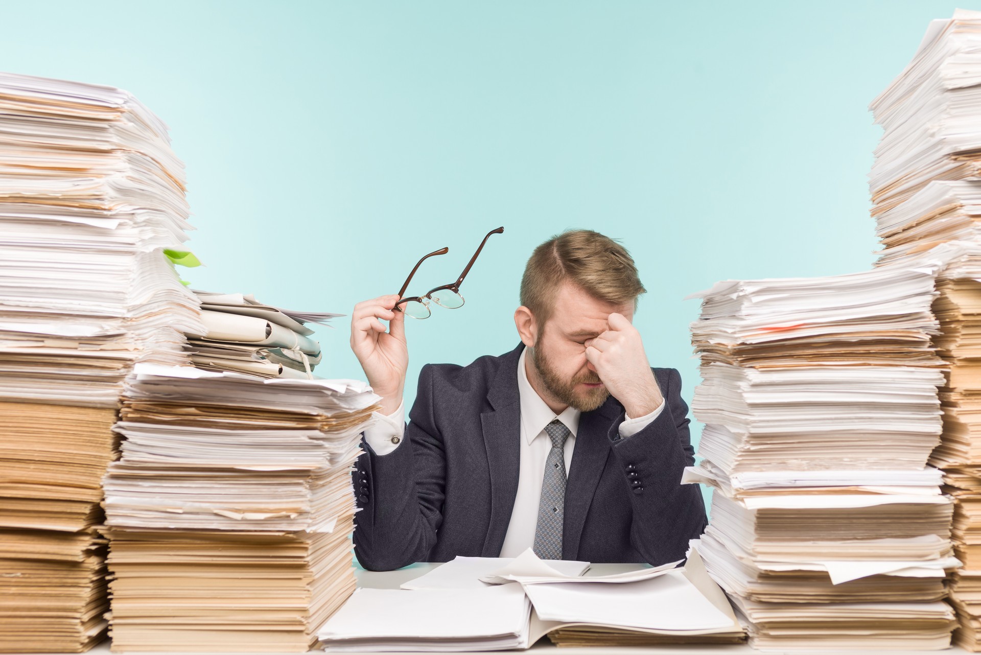 Close-up image of a stressful businessman tired from his work on the foreground