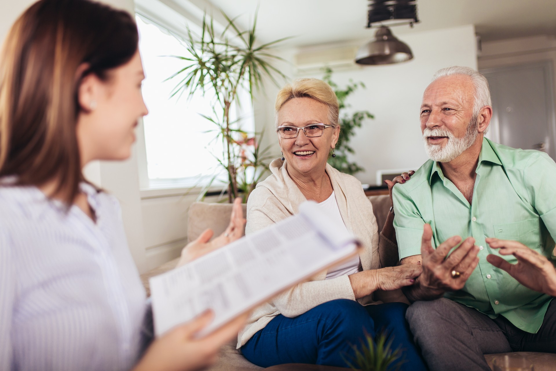 Positive aged couple consulting with insurance agent